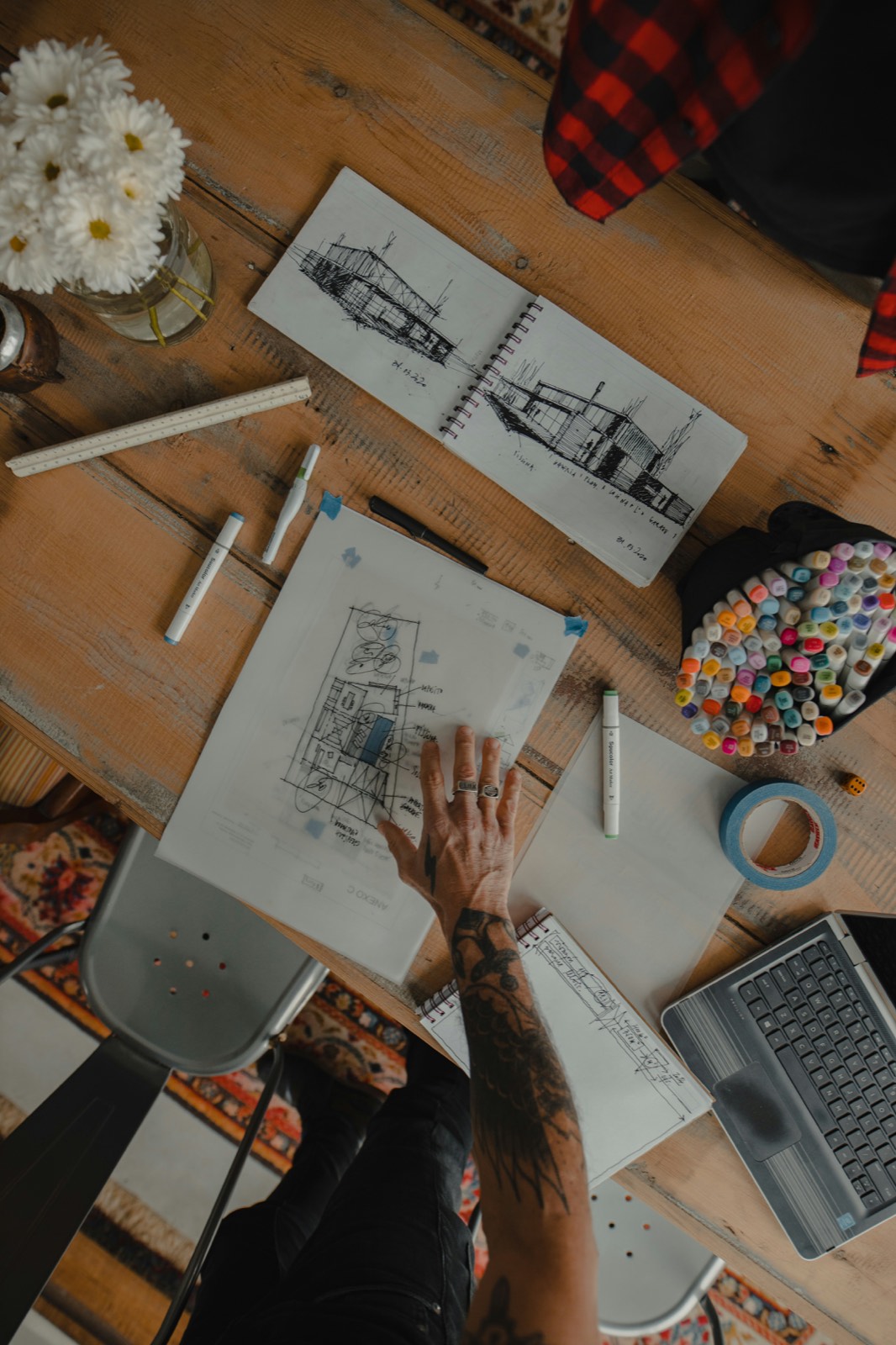 Hand over architectural sketches on a table