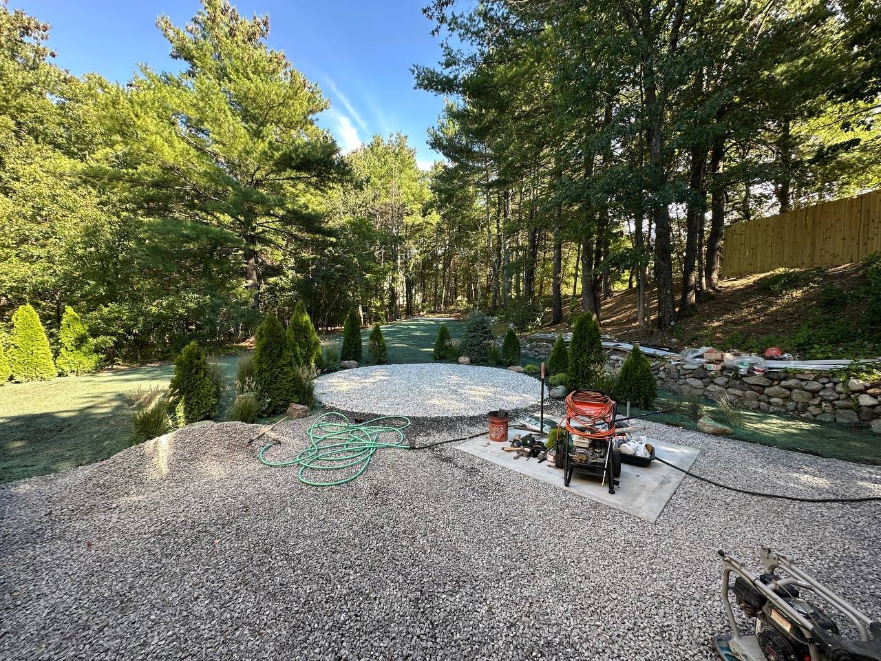 Gravel terrace and circular pad looking into the woods