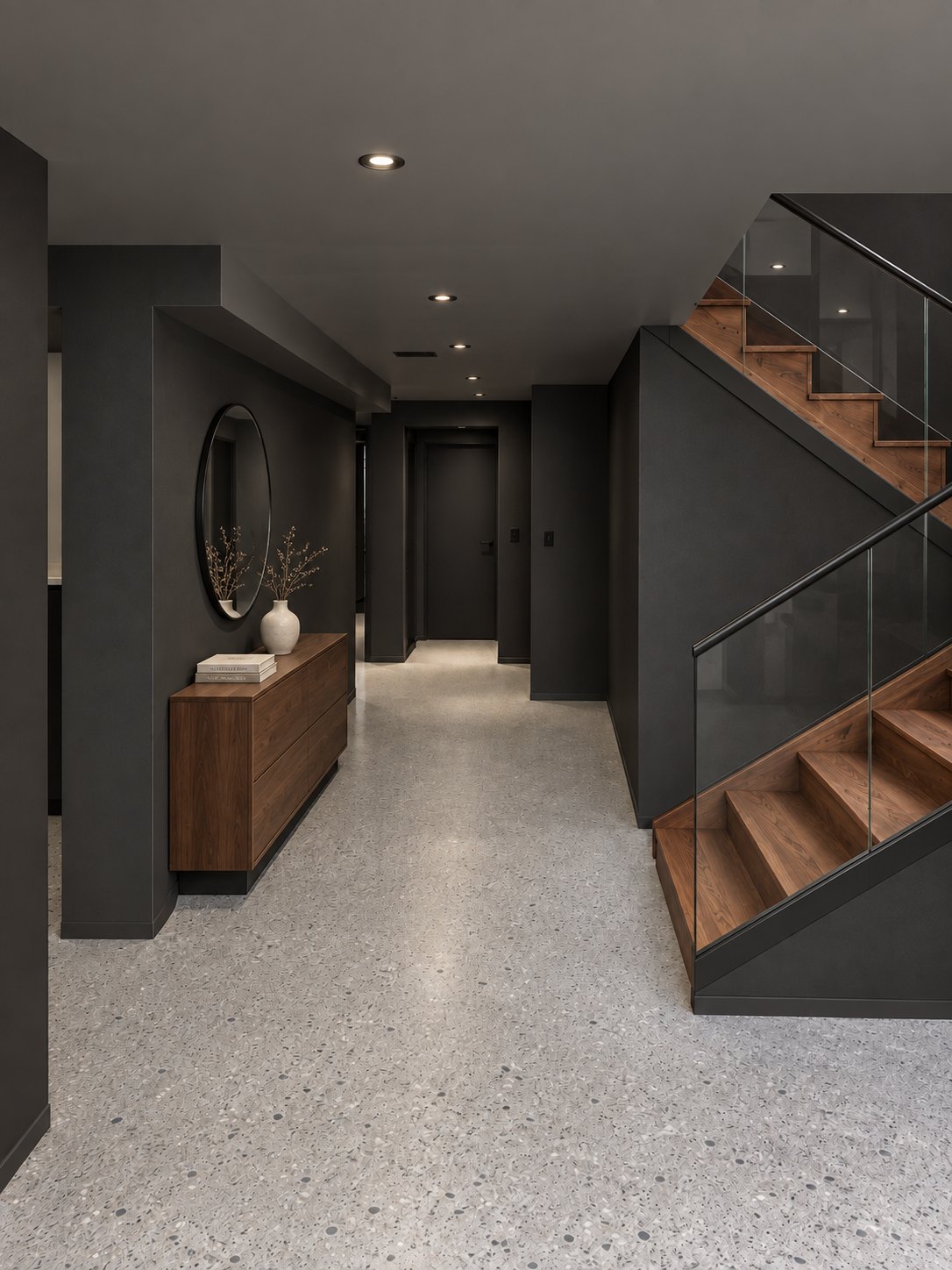 Dark hallway with terrazzo floor and a wood stair