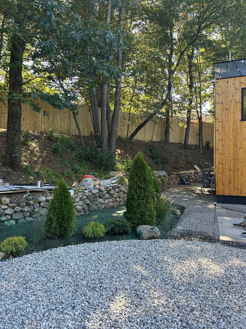 Wood privacy fence along the bank behind the house