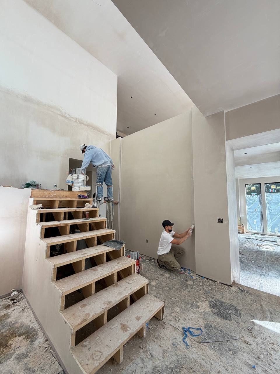 Stair under construction, with plaster still going on the walls