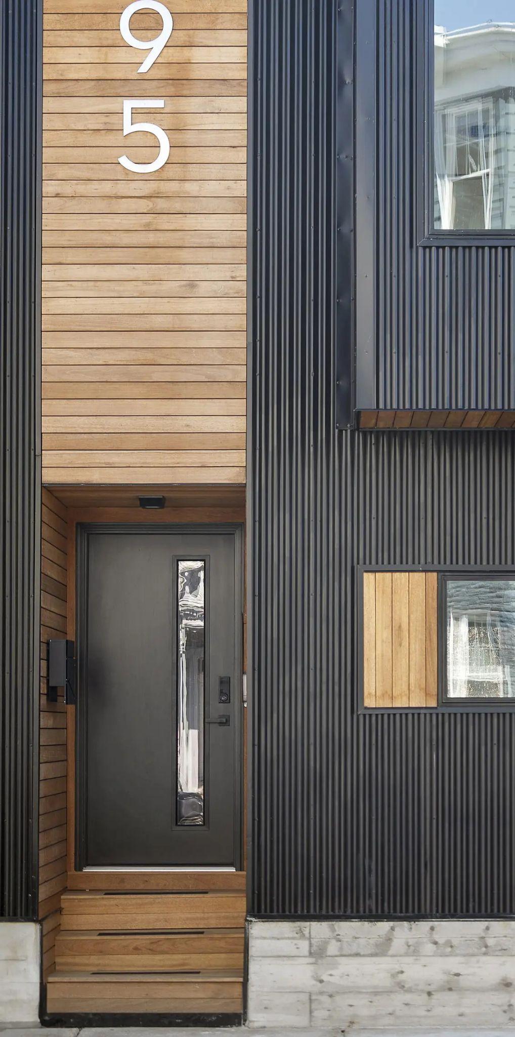Cedar entry, black door, and the number 95
