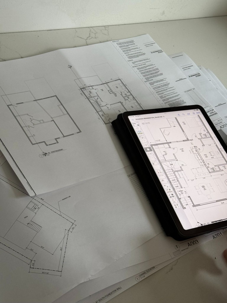 Floor plans for 95 Bennington Street, on paper and on a tablet