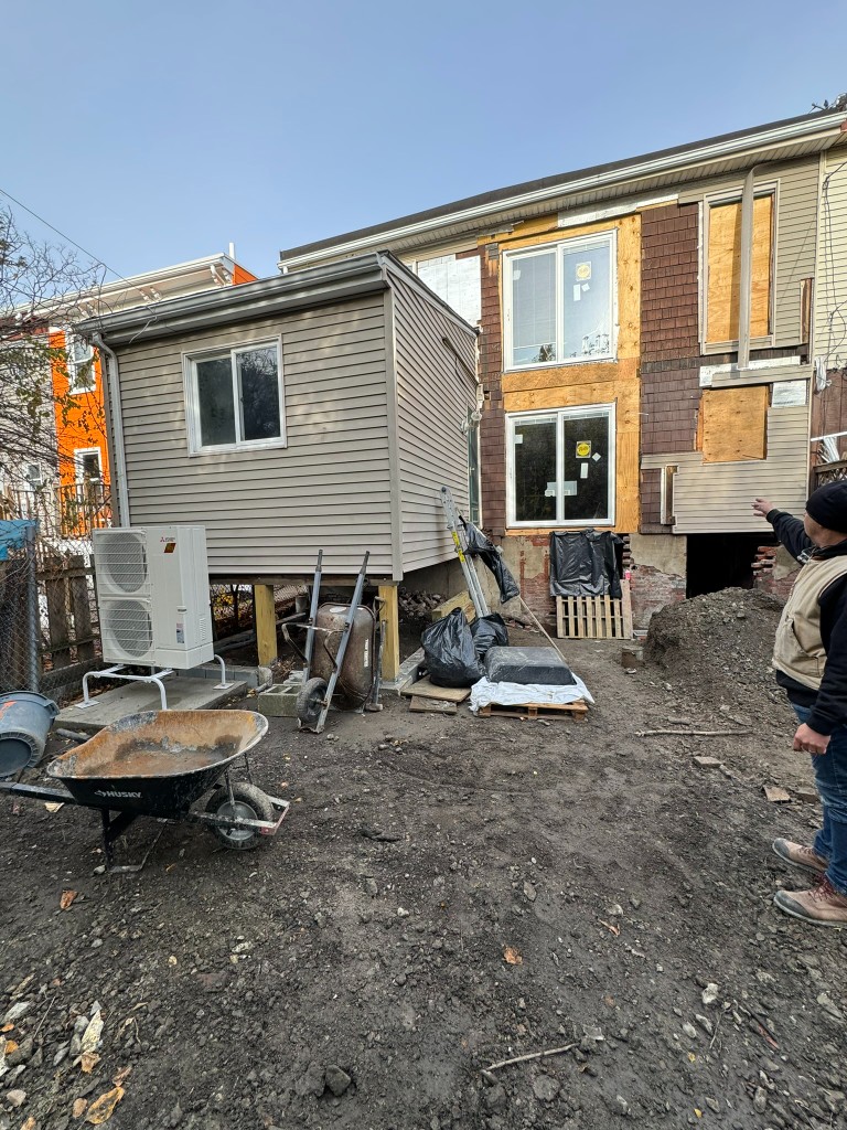 The house opened up at the rear, with a heat pump and the yard dug out