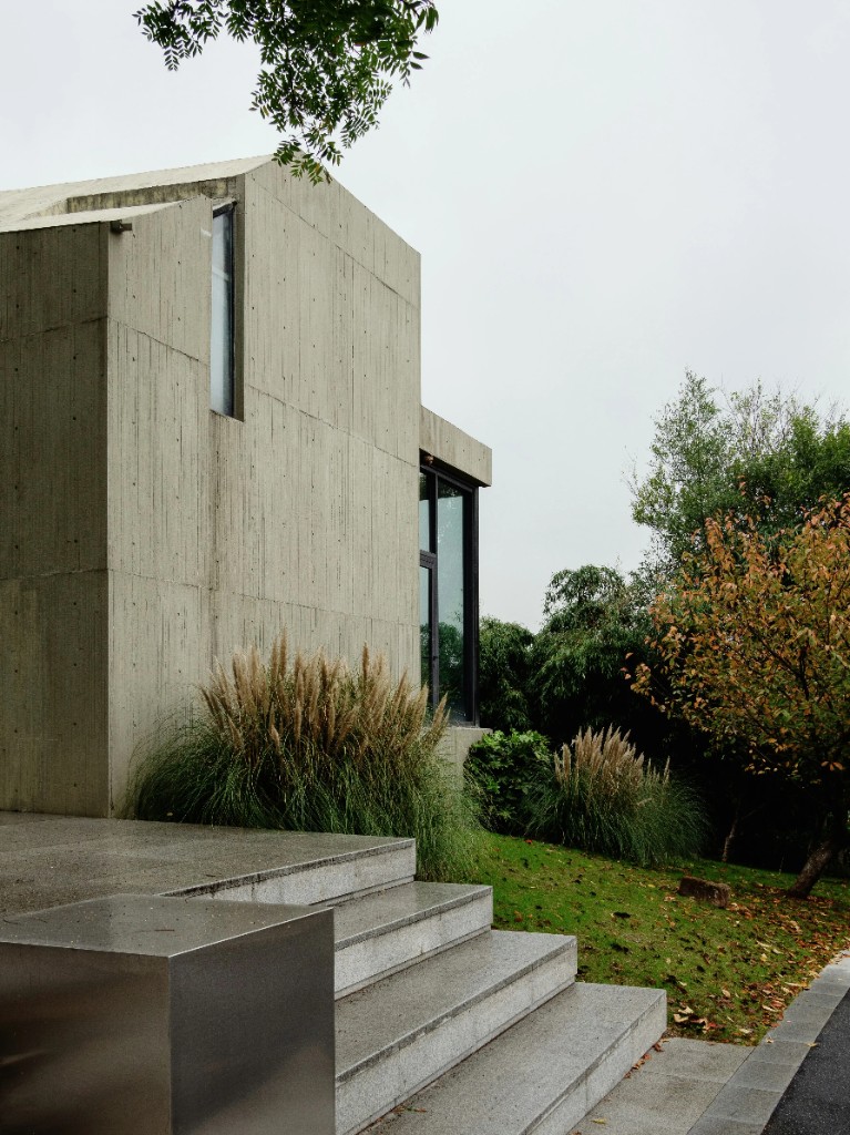 Concrete home exterior with garden